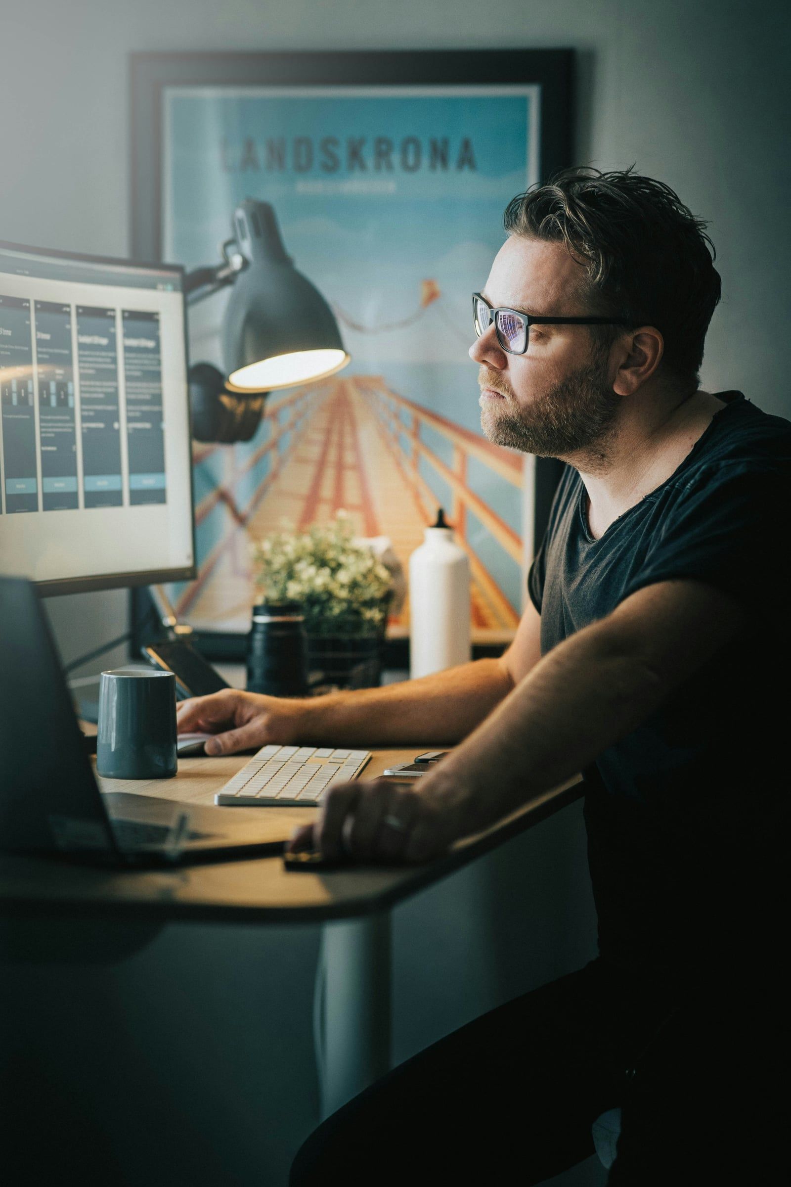Designer working at a desktop computer in a studio