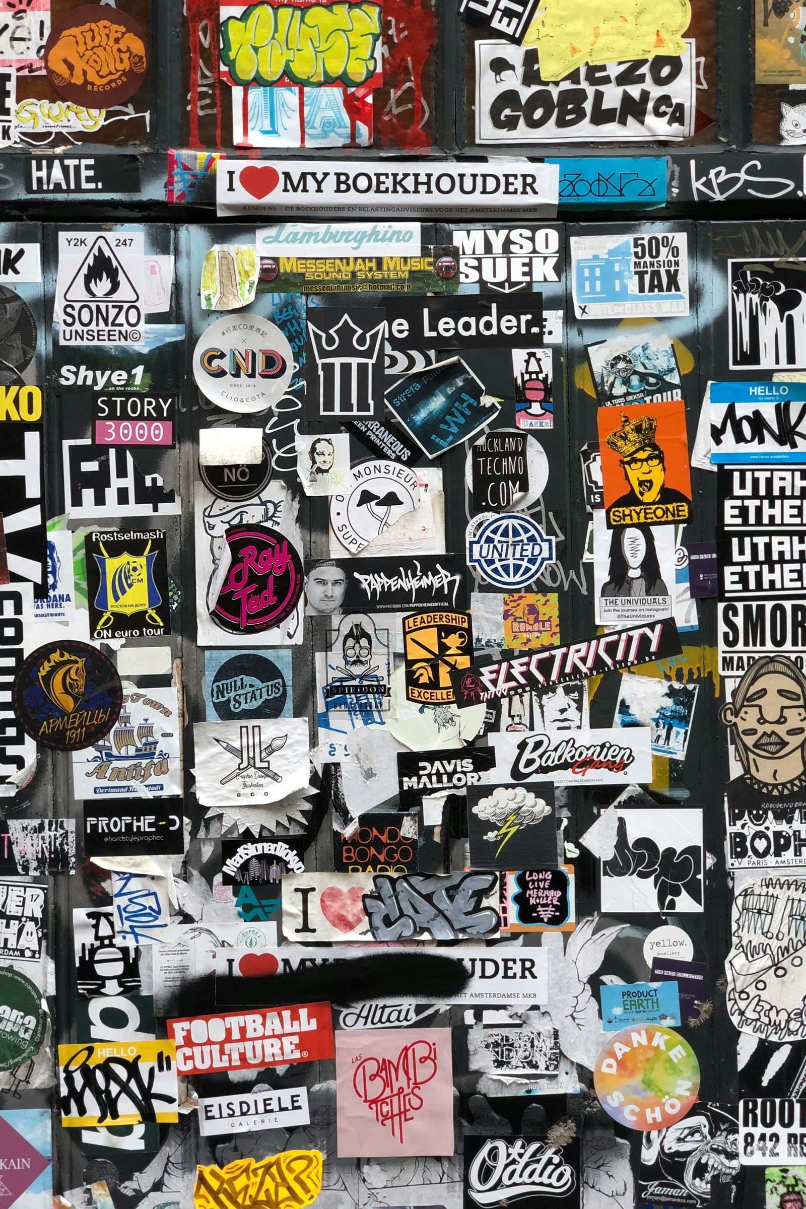 Wall covered in stickers and logos